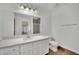 Well-lit bathroom with a large vanity, tiled floor, and glass-enclosed shower at 5845 Killala Ct, Las Vegas, NV 89110