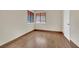 Bright bedroom with wood-look tile, large windows, and a neutral color scheme at 5845 Killala Ct, Las Vegas, NV 89110