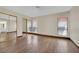 Spacious bedroom with wood-look tile floors, large windows, and mirrored closet doors at 5845 Killala Ct, Las Vegas, NV 89110