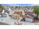 Exterior aerial view of homes with tile roofs, desert landscaping, and attached garages at 5845 Killala Ct, Las Vegas, NV 89110