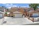 Aesthetic exterior elevation featuring a tile roof and a large driveway leading to attached garages at 5845 Killala Ct, Las Vegas, NV 89110