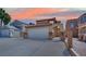Charming home featuring a tile roof, an attached two-car garage, and a gated front entry with desert landscaping at 5845 Killala Ct, Las Vegas, NV 89110