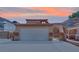 Beautiful home showcasing a tile roof, an attached two-car garage, and a gated front entry with well-kept landscaping at 5845 Killala Ct, Las Vegas, NV 89110