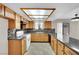 Charming kitchen features wooden cabinets, gray countertops, and mosaic tile backsplash at 5845 Killala Ct, Las Vegas, NV 89110