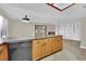 Kitchen island featuring a dishwasher and wood cabinets with granite countertops at 5845 Killala Ct, Las Vegas, NV 89110