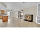 Cozy living room with fireplace, tile flooring, and sliding glass doors leading to the patio at 5845 Killala Ct, Las Vegas, NV 89110