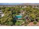 Aerial view of community swimming pool and landscaping, surrounded by mature trees at 609 Greenbriar Townhouse Way, Las Vegas, NV 89121