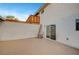 Enclosed backyard with brick patio, ladders, and door to the interior at 609 Greenbriar Townhouse Way, Las Vegas, NV 89121