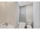 Contemporary bathroom with white tiled shower, white toilet, and a new vanity at 609 Greenbriar Townhouse Way, Las Vegas, NV 89121