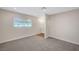 Spacious bedroom features neutral walls, plush carpet, and a window for natural light at 609 Greenbriar Townhouse Way, Las Vegas, NV 89121