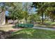 Charming community featuring a green bridge amidst lush trees and landscaping at 609 Greenbriar Townhouse Way, Las Vegas, NV 89121
