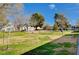 Open lawn area in front of condos, accentuated by mature shade trees and blue skies at 609 Greenbriar Townhouse Way, Las Vegas, NV 89121