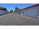 View down long driveway of multiple garage units in residential community at 609 Greenbriar Townhouse Way, Las Vegas, NV 89121