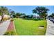 Expansive grassy courtyard featuring meticulous landscaping and mature trees at 609 Greenbriar Townhouse Way, Las Vegas, NV 89121