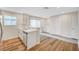 Charming kitchen with stainless steel appliances, white cabinets, and wood flooring at 609 Greenbriar Townhouse Way, Las Vegas, NV 89121