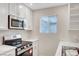 Updated kitchen features stainless appliances, marble countertops, and ample cabinet space at 609 Greenbriar Townhouse Way, Las Vegas, NV 89121