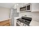 Bright kitchen boasts stainless appliances and marble countertops at 609 Greenbriar Townhouse Way, Las Vegas, NV 89121
