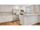 Gorgeous kitchen featuring stainless steel appliances, white cabinetry, and new floors at 609 Greenbriar Townhouse Way, Las Vegas, NV 89121