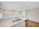 Modern kitchen featuring stainless steel appliances and stylish marble countertops at 609 Greenbriar Townhouse Way, Las Vegas, NV 89121