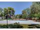 Community pool surrounded by mature trees and green landscape at 609 Greenbriar Townhouse Way, Las Vegas, NV 89121