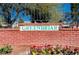 Close up of Greenbriar signage in front of brick wall and mature trees at 609 Greenbriar Townhouse Way, Las Vegas, NV 89121