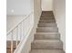 Carpeted staircase with white railing leading to the upper level at 609 Greenbriar Townhouse Way, Las Vegas, NV 89121