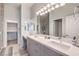 Bright bathroom features a double sink vanity, large mirror, and walk-in closet at 6437 Wide Sky St, Las Vegas, NV 89166