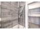 Modern bathroom shower features gray tile and a glass door at 6437 Wide Sky St, Las Vegas, NV 89166