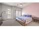 Bedroom features a comfortable bed, bench, and access to a balcony at 6437 Wide Sky St, Las Vegas, NV 89166