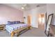 Bedroom featuring a comfortable bed, bench, and neutral gray carpet at 6437 Wide Sky St, Las Vegas, NV 89166