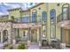 Inviting townhome featuring arched windows, private balcony, and a beautifully landscaped entrance at 6437 Wide Sky St, Las Vegas, NV 89166