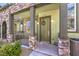 Close-up of a welcoming front door with stone accents, charming decor, and stylish lighting at 6437 Wide Sky St, Las Vegas, NV 89166