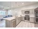 Bright kitchen boasts a breakfast bar, stainless appliances, and modern pendant lighting at 6437 Wide Sky St, Las Vegas, NV 89166