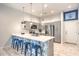 Modern kitchen features a breakfast bar with seating and stainless steel appliances at 6437 Wide Sky St, Las Vegas, NV 89166
