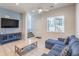 Comfortable living room featuring large television, console, and modern ceiling fan at 6437 Wide Sky St, Las Vegas, NV 89166