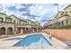 Inviting community pool with clear blue water, surrounded by well-kept townhomes and landscaping at 6437 Wide Sky St, Las Vegas, NV 89166