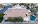 Aerial view of a home with a tile roof, lush landscaping, including palms, and a sparkling pool and spa at 6493 Yellow Bells Ct, Las Vegas, NV 89131