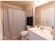 Bathroom with a shower-tub combo with black accents, single sink vanity, and white colored walls and accents at 6493 Yellow Bells Ct, Las Vegas, NV 89131