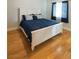 Bedroom featuring a bed with a white frame, a blue comforter and light hardwood flooring at 6493 Yellow Bells Ct, Las Vegas, NV 89131