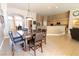 Dining area adjacent to the kitchen and living room, featuring a large table and neutral tones at 6493 Yellow Bells Ct, Las Vegas, NV 89131