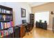 A dedicated office space features a full-size desk, lots of book storage and natural lighting at 6493 Yellow Bells Ct, Las Vegas, NV 89131