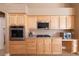 A close up of a light wood kitchen featuring modern appliances and ample counter space at 6493 Yellow Bells Ct, Las Vegas, NV 89131