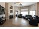 Bright and airy living room featuring tile floors, a fireplace, and comfortable seating at 6493 Yellow Bells Ct, Las Vegas, NV 89131