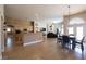 A large, open-concept living area flows to a dining area, and features neutral colors and tile flooring at 6493 Yellow Bells Ct, Las Vegas, NV 89131