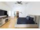 Spacious main bedroom showcasing hardwood flooring, a modern entertainment center, and ample natural light at 6493 Yellow Bells Ct, Las Vegas, NV 89131