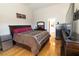Cozy main bedroom with wood floors, neutral walls, and a large bed at 6493 Yellow Bells Ct, Las Vegas, NV 89131