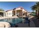 Backyard pool and spa with tanning ledges, a covered patio, and outdoor seating at 6493 Yellow Bells Ct, Las Vegas, NV 89131