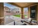 Inviting backyard featuring a covered patio, gravel area, artificial turf, and an outdoor fire pit at 7109 Red Gulch St, North Las Vegas, NV 89084