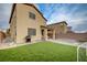 Well-maintained backyard featuring artificial grass, a barbecue grill, and patio area at 7109 Red Gulch St, North Las Vegas, NV 89084