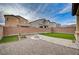 Spacious backyard showcasing gravel landscaping, artificial turf, a fire pit, and block wall fencing at 7109 Red Gulch St, North Las Vegas, NV 89084